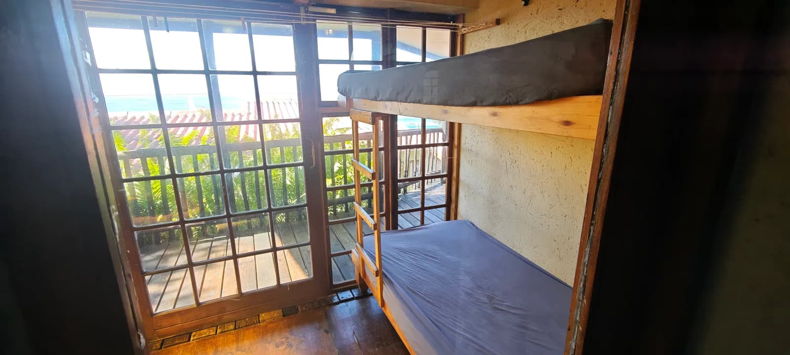 Bunk beds beside the full-height windows