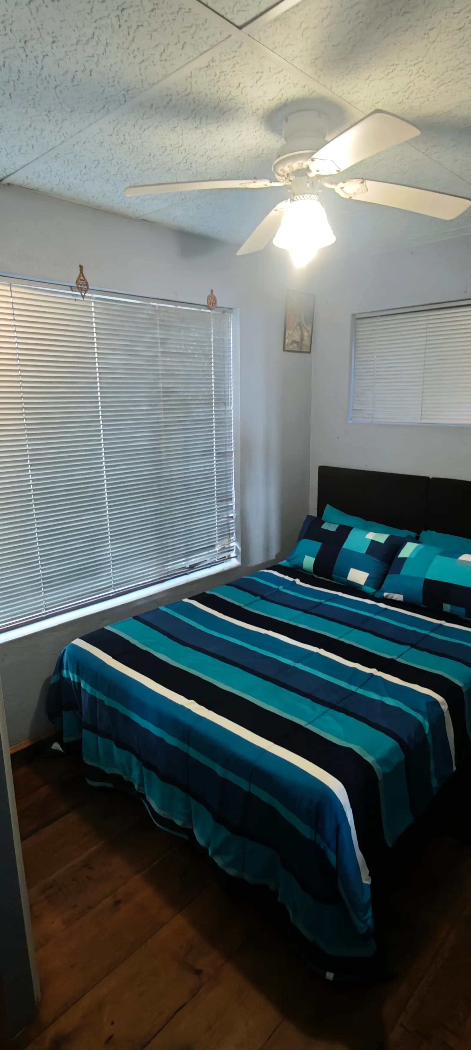 Second bedroom with a bed beside the window